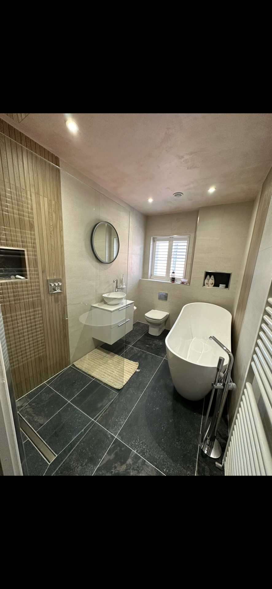 Master bathroom with freestanding tub, slate floor and oak-panelled walk-in shower — bathroom installation Woking