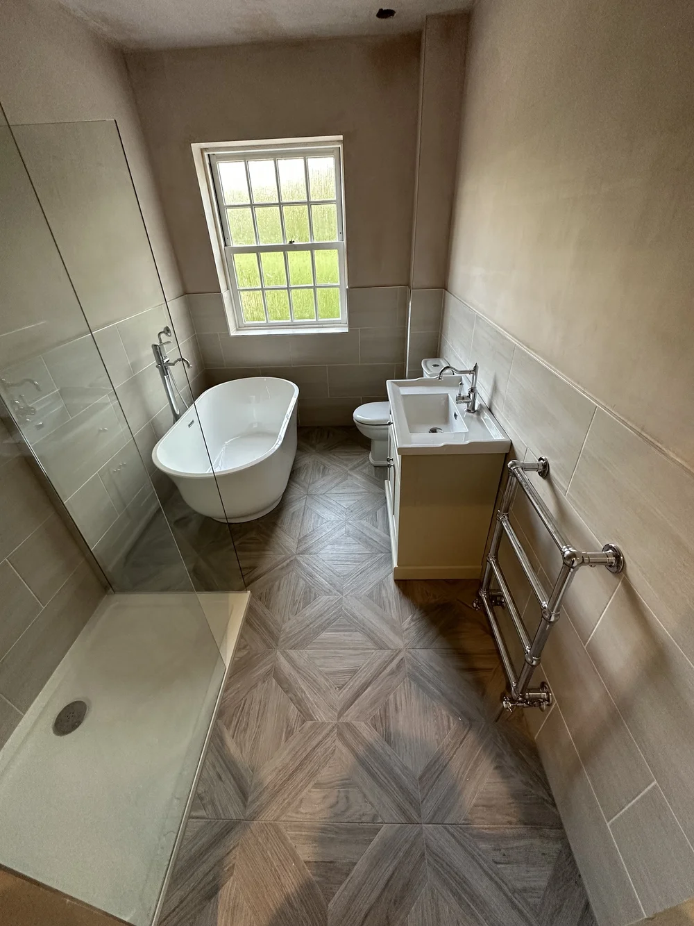 Traditional bathroom with freestanding slipper bath, cream shaker vanity and parquet floor — bathroom renovation Woking