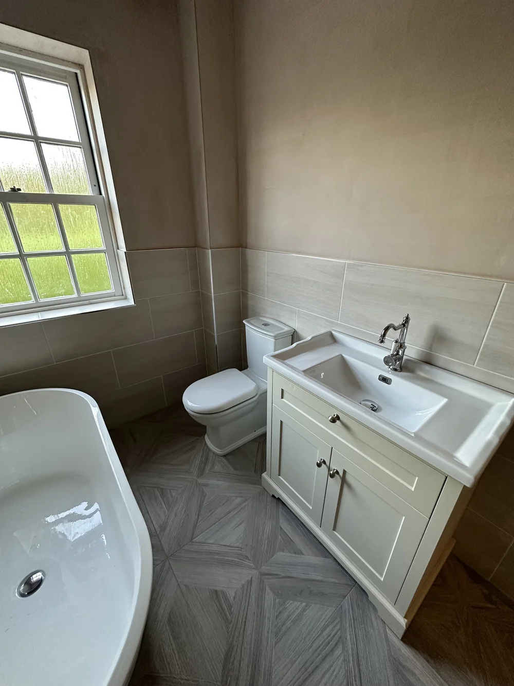 Traditional bathroom with cream shaker vanity, chrome tap and parquet floor — bathroom renovation Woking